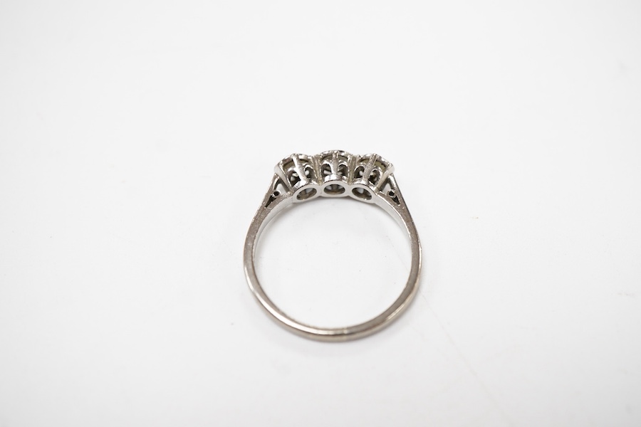 A three-stone diamond ring, set with three brilliant-cut diamonds totalling approximately 0.50 carats, mounted in platinum, size R1/2, British hallmarks, gross weight approximately 4 grams